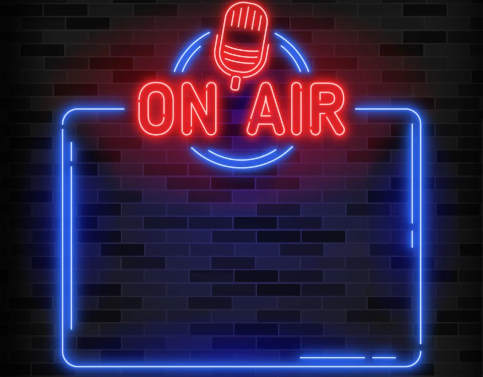 ON AIR" poster in red and blue neon on a brick background with technical diagram in the background